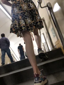 Low angle pics of a candid girl wearing a dress with long and very slim legs
