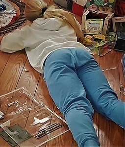 Teen girl wearing jeans lying on the floor
