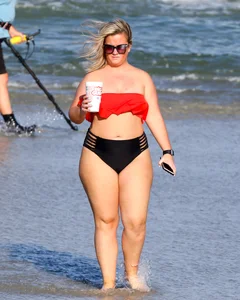 Thick BBW blonde lady in a bikini at the beach