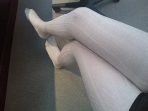 Crossed Skinny Legs in White Tights Closeup Selfie