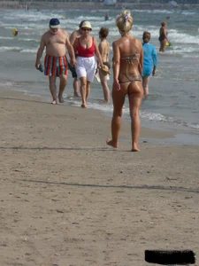 Tattooed blonde with big tits topless and in thong