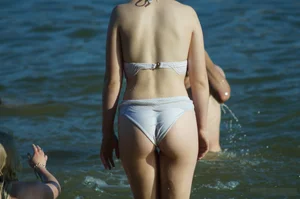 Girl with Pale Skin and Hot Round Booty in White Swimsuit Beach Candid Pics