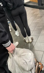 Tight ass sports team in line at airport