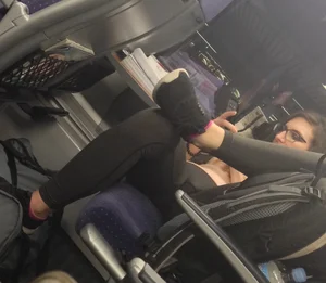 Girl Lying on the Bus Seat in Yoga Pants with Spread Legs