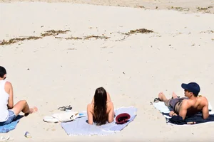 Blue bikini girl on the beach with a great ass and a little pussy lips slips