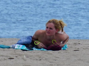 Sexy ass blonde milf on the beach in a thong with cameltoe and bending over