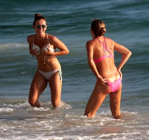 Sexy beach girl in bikini with her other sexy friend