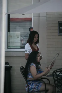 Two sexy Tilted Kilt employees showing cleavage and cheeks