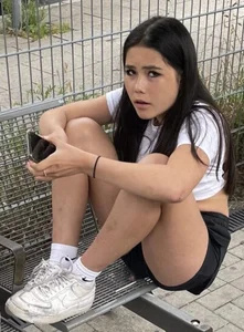 Teen in shorts sitting on a bench