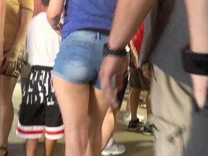 Bunch of girls in various outfits at a Cardinals baseball game