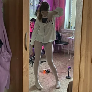 Skinny girl in white pantyhose home mirror selfies and closeup of her legs on table