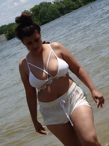 Big boobed brunette on the beach in white bikini