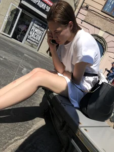 Girl with hot slim legs and high-heeled sandals sitting on a street bench creepshots