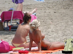 Tattooed blonde with big tits topless and in thong