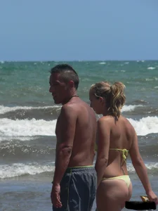 Sexy blonde on the beach in a yellow thong bikini
