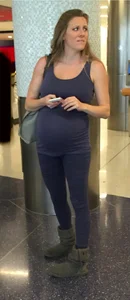 Pregnant blonde girl in leggings at the airport