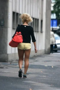 Blonde looking sexy walking in short yellow shorts