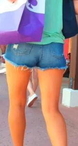 Candid girl in denim shorts with nice legs and showing her cheeks