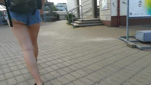 Girl walking in denim shorts showing some of her ass cheeks