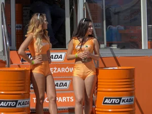 Sexy ass auto show girls showing their cheeks in little orange shorts