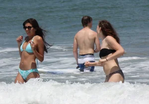 Brunette and redhead on the beach in bikinis looking sexy