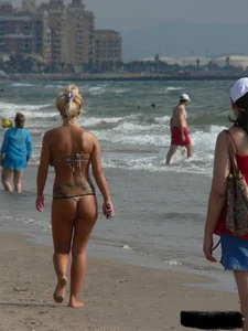 Tattooed blonde with big tits topless and in thong