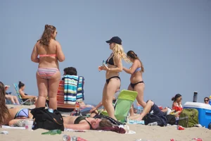 Two thick white girls in bikinis on the beach with big asses