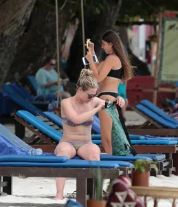 Sexy brunette friends on the beach in bikinis with great bodies
