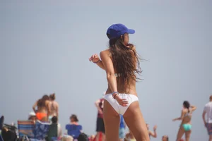 Beach football sexy brunette in white bikini