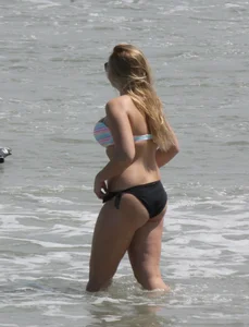 Big boobed thick blonde on the beach in a bikini