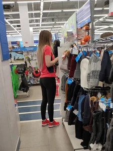 Cute Girl in Yoga Pants in a Store Candid Photo