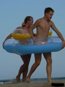 Sexy mom and daughter in red thongs at the beach