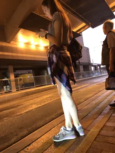 Cute Teen in Shorts on the Tram Stop