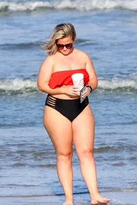 Thick BBW blonde lady in a bikini at the beach