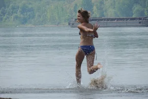 Skinny teen having fun in her little England bikini