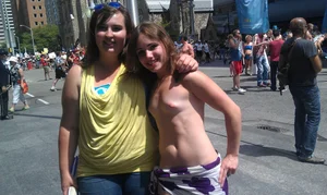 Nude small boobed girl at Toronto pride parade with a couple bonus girls
