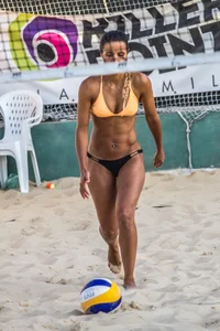 Hot girls playing beach volleyball in bikinis and shorts