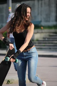 Hot brunette skateboarder in tight jeans and with hard nipples