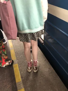 Cute Teen Girl in a Skirt And Sneakers With Very Pale Skin, Candid Photos in Subway