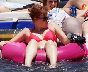 Sexy party girls in bikinis on a lake