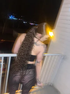 Tattooed party girl wearing a top and almost transparent tights