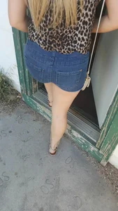 Booty in denim and slim legs, girl entering a building