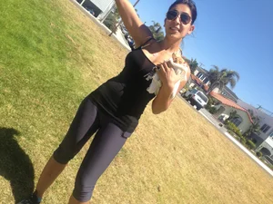 Hot brunette babe in leggings walking her dog with a nice ass and some cleavage