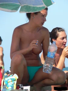 Bunch of sexy babes on the beach topless and in thong bikinis