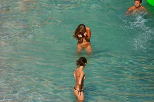 FKK Nudists playing in the water with floater