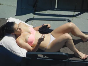 Candid flat-chested girl with a long torso in a swimsuit lying on sunbed creepshots