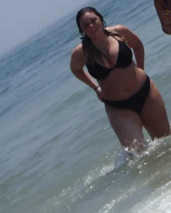 Thick beach babe with big tits in a thong bikini