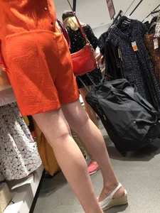 Hot Legs in Orange Dress and High Heeled Sandals Store Candid Photo