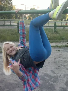 Teen in Yoga Pants Upside Down on the Playground
