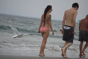 Peach bikini tattood babe on the beach with a nice ass and some camel toe